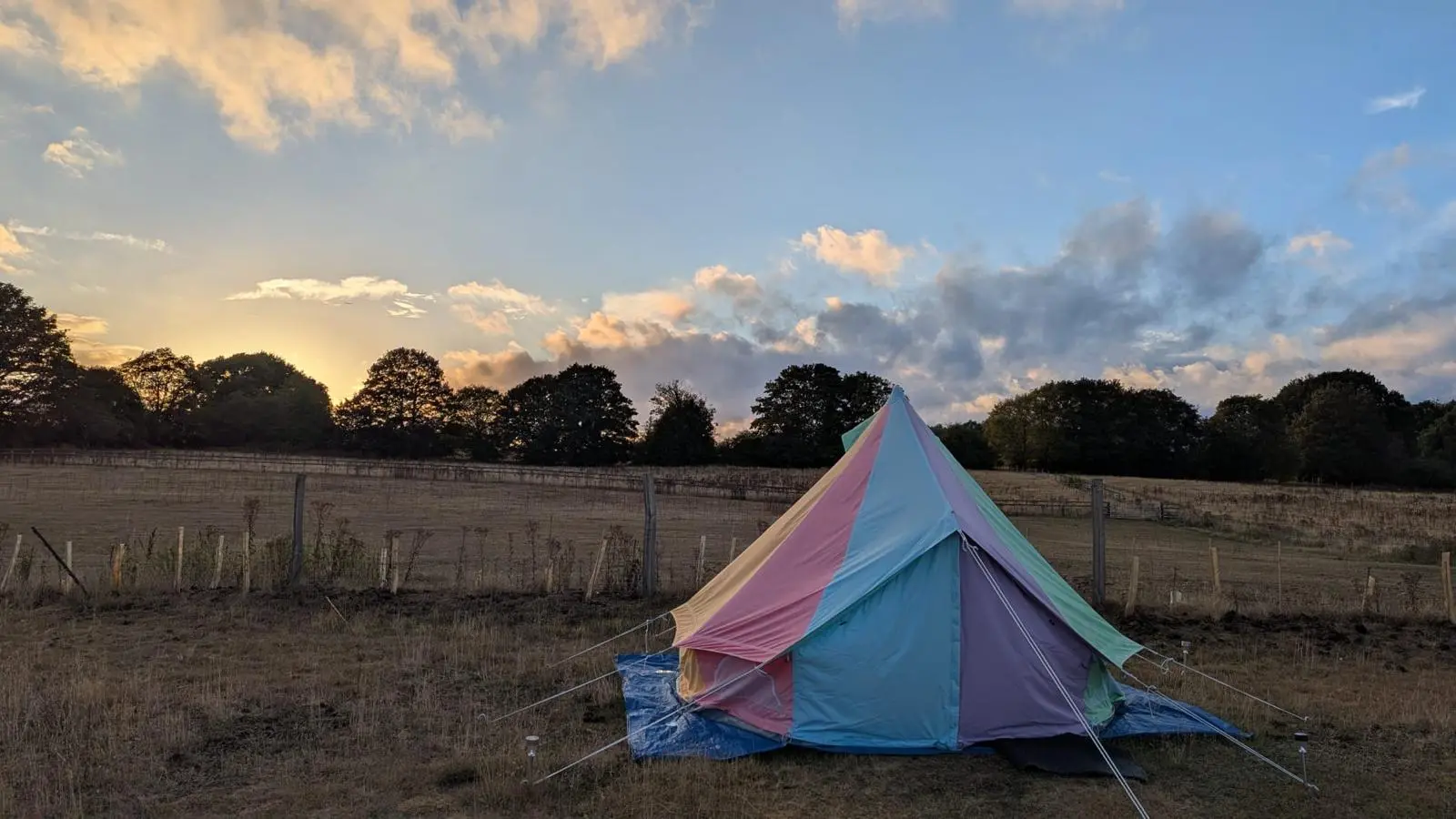 Bell tent on the field at sunset