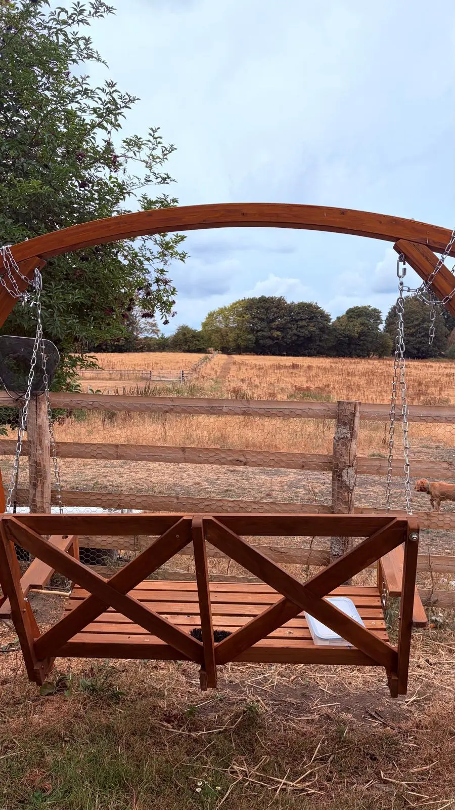 Wooden swing looking out over the field