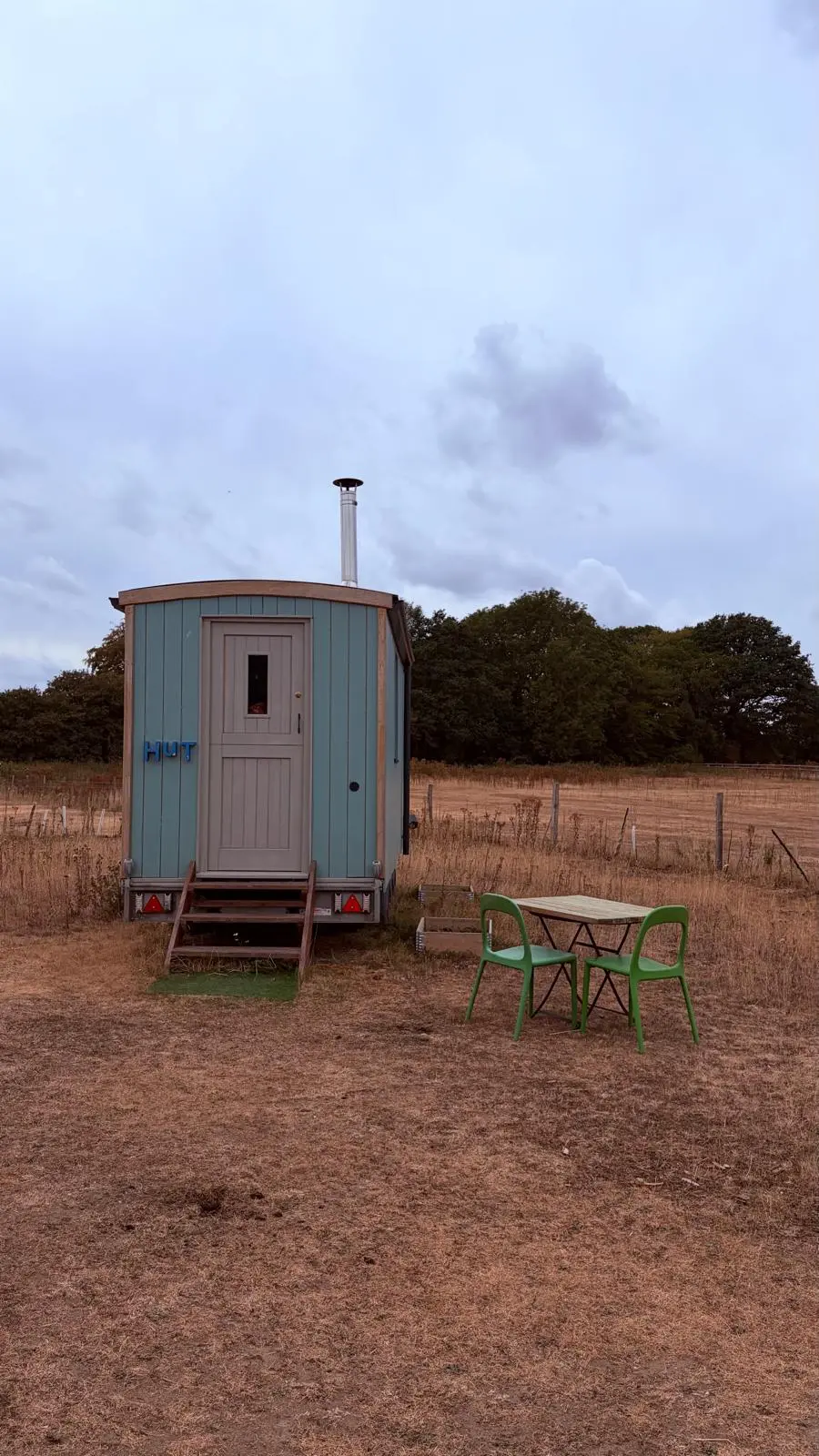 The small hut from outside on the field